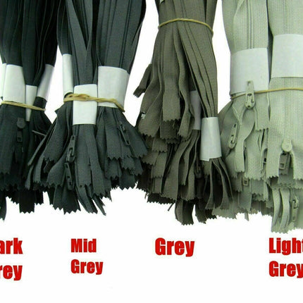 A product display panel showing various neutral shades of grey Trebla nylon coil zippers for tailoring and cushions.
