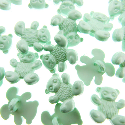 Green teddy bear-shaped candies on a white background