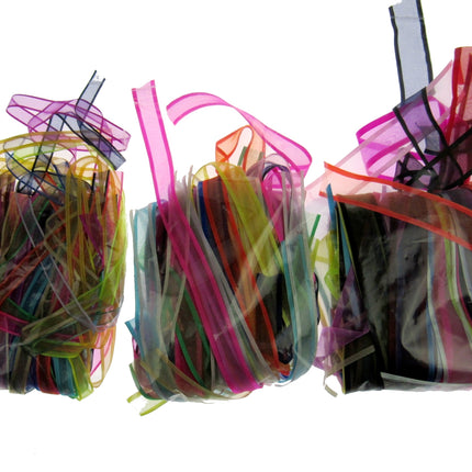 Colorful lengths of chiffon ribbon in clear bags on a white background
