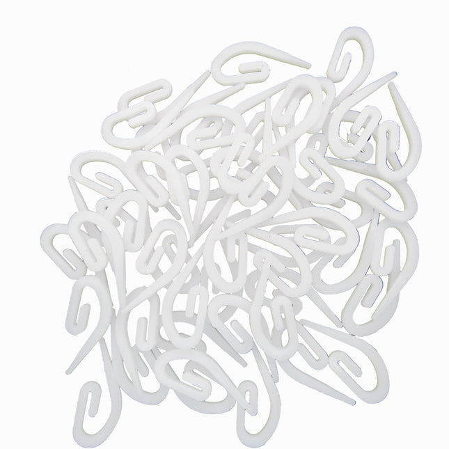 White plastic hooks on a white background