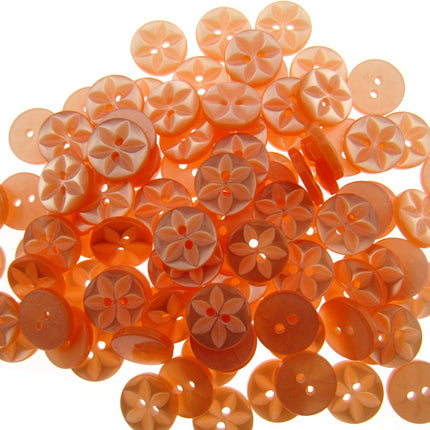 An array of colorful round star-shaped baby buttons in various colors including green, orange, pink, purple, yellow, and clear.