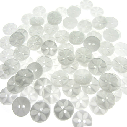 An array of colorful round star-shaped baby buttons in various colors including green, orange, pink, purple, yellow, and clear.