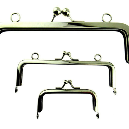 A collection of silver metal purse frames on a white background