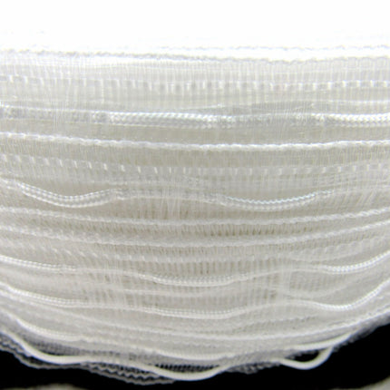 A roll of white, translucent Austrian blind curtain tape with cross loops for draw cords, displayed on a black background.