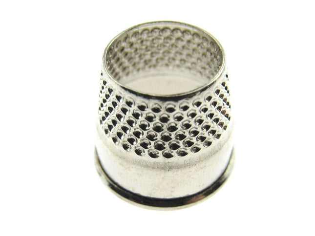 A stainless steel open end tailors thimble on a white background