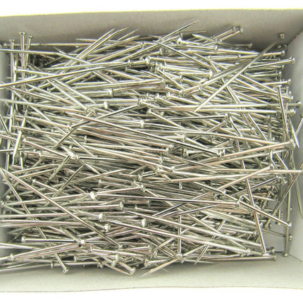 A box filled with nickel plated pins, approximately 1000 pins, displayed in araft box.