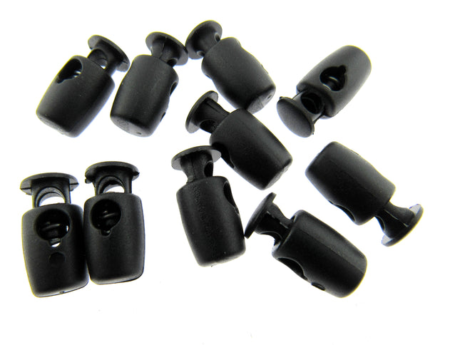 A selection of black mini cord locks for facemask tension adjustment on a white background