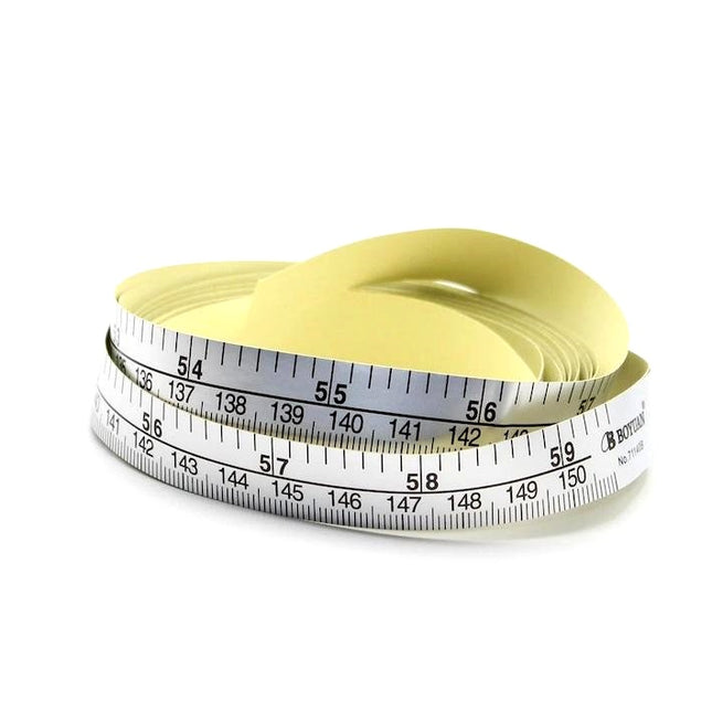 A silver-colored self-adhesive tape measure with printed measurements, partially unrolled and showing the measurement markings.