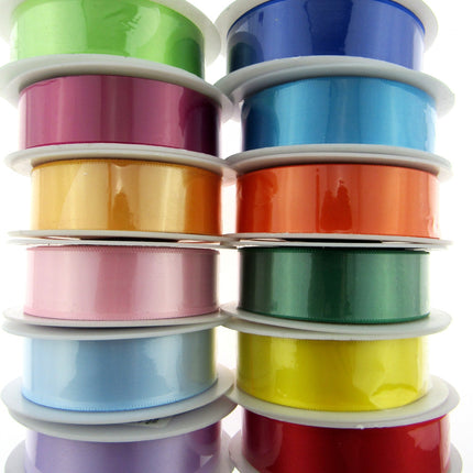 A collection of satin ribbons with woven edges, displayed in various colors.