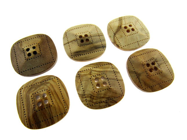 Six square-shaped, beige-colored wooden buttons with four holes each, made from olive wood, displayed on a white background