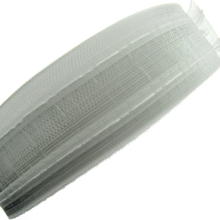 A translucent net pleat curtain tape rolled up.