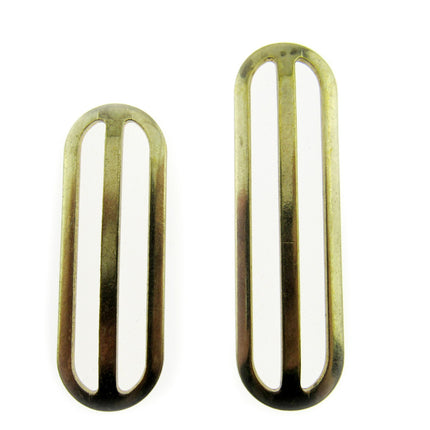 Two gold metal sliders with a rectangular shape, used for adjusting webbing strap length.